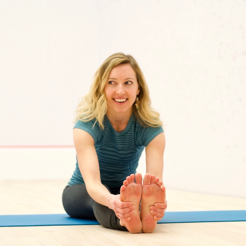 Jane sitting legs extended with foot grab